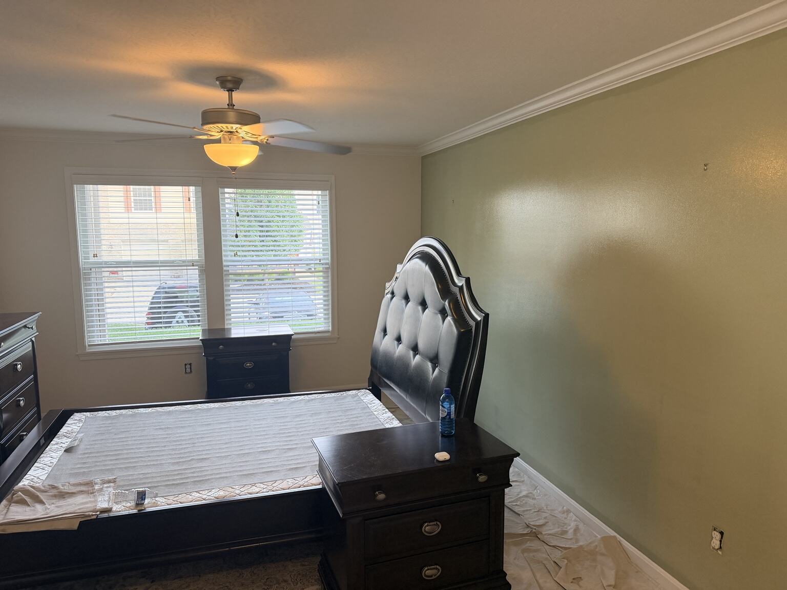 Fresh green bedroom accent wall with crisp white trim